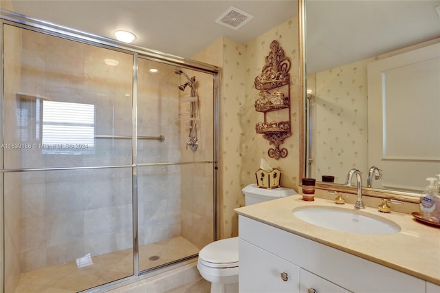 bathroom featuring walk in shower, toilet, and vanity