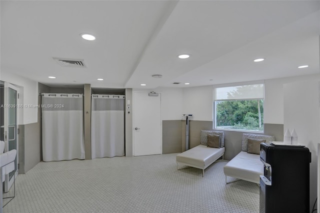 living area with light colored carpet