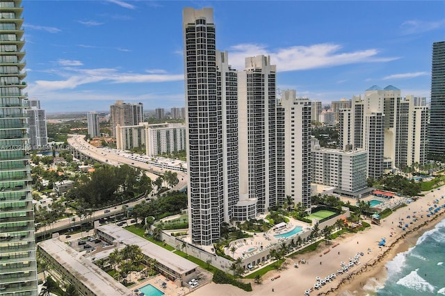 property's view of city with a view of the beach and a water view