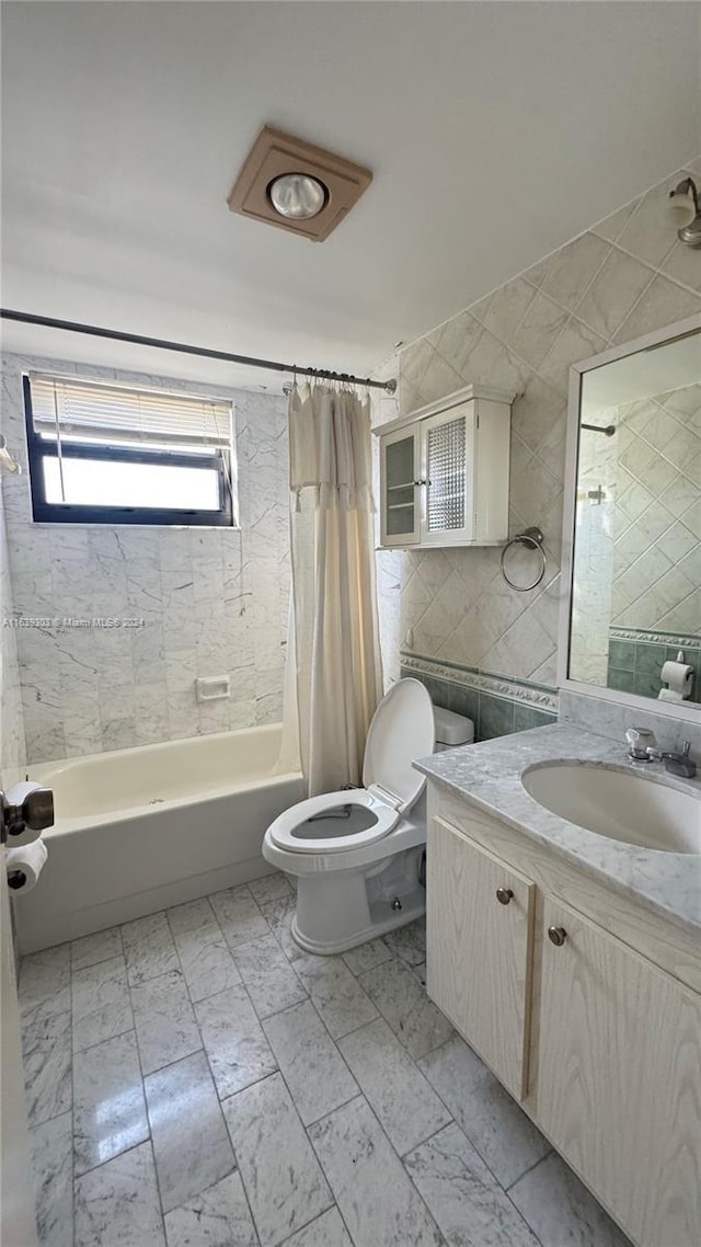 full bathroom featuring toilet, vanity, and shower / tub combo with curtain