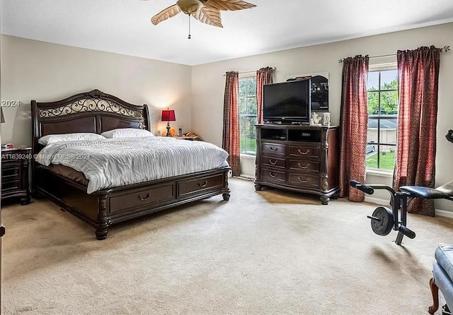 bedroom featuring ceiling fan and light colored carpet