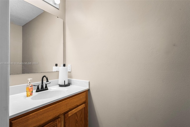 bathroom with a textured ceiling and vanity