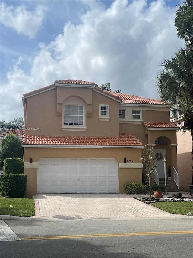 mediterranean / spanish-style home featuring a garage