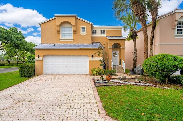 view of front of home featuring a front lawn and a garage