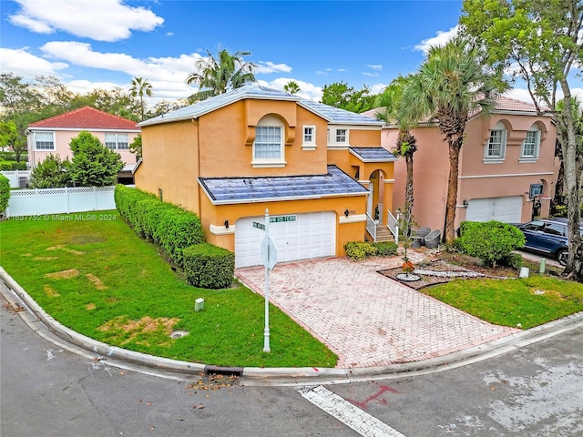 view of front of home with a front yard and a garage