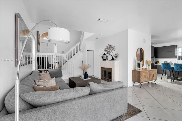 tiled living room with a tiled fireplace