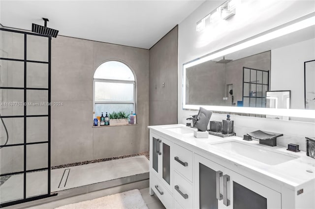 bathroom featuring vanity, tile patterned floors, and walk in shower