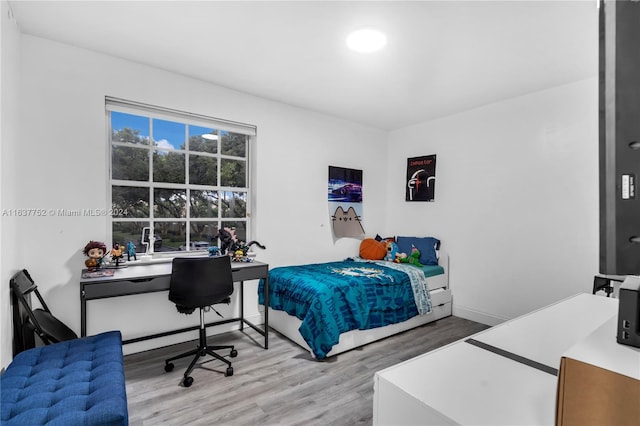 bedroom with hardwood / wood-style flooring