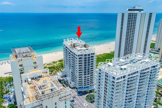 drone / aerial view with a beach view and a water view