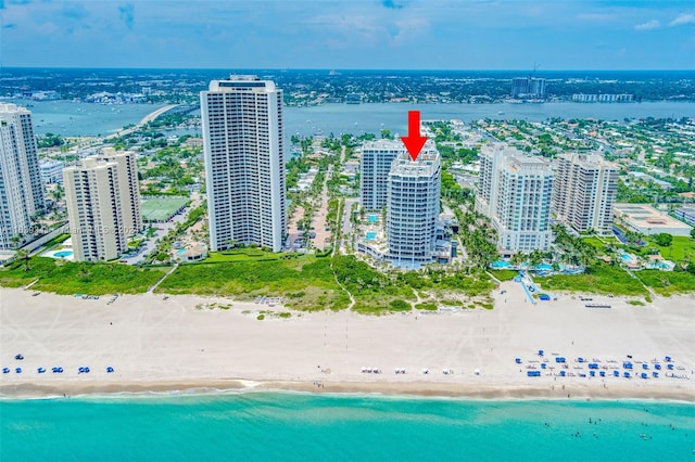 birds eye view of property featuring a water view and a view of the beach