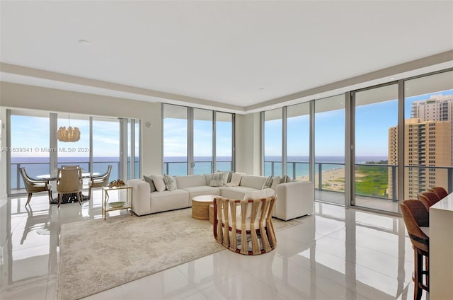 tiled living room with a healthy amount of sunlight and a water view