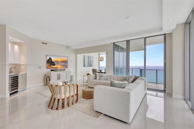 tiled living room with wine cooler and a wall of windows