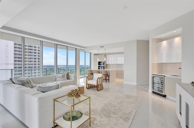 living room with a wall of windows, beverage cooler, and light tile patterned floors