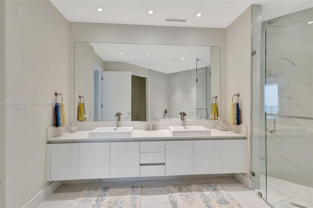 bathroom featuring double sink vanity, walk in shower, and tile patterned flooring