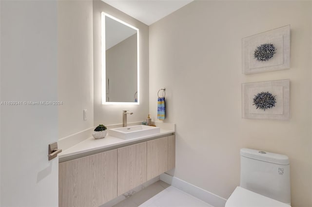 bathroom featuring vanity, toilet, and tile patterned flooring