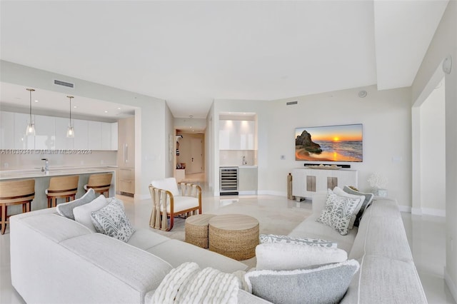 living room with light tile patterned flooring and wine cooler