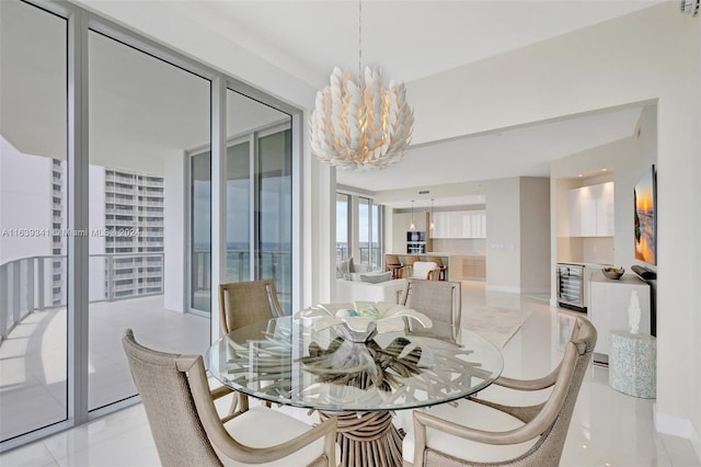 dining space with light tile patterned flooring, beverage cooler, and an inviting chandelier