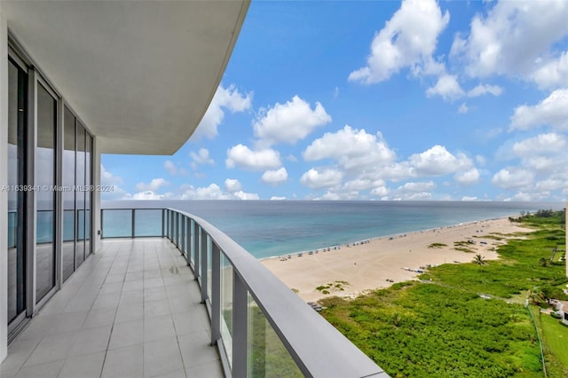 balcony with a water view and a beach view