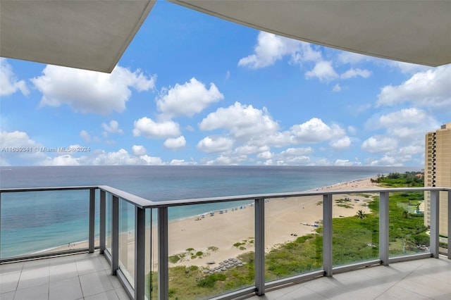 balcony with a beach view and a water view