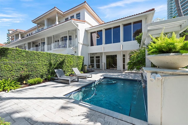 view of pool featuring pool water feature and a patio area