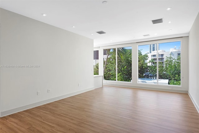 unfurnished room with light hardwood / wood-style floors