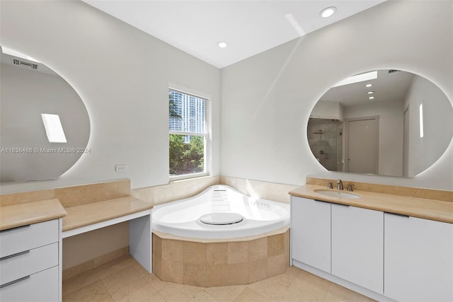 bathroom with shower with separate bathtub, tile patterned floors, and vanity