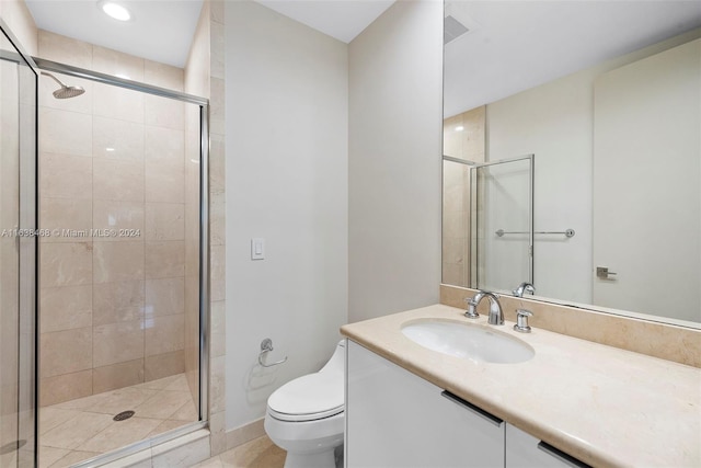 bathroom with walk in shower, vanity, and toilet