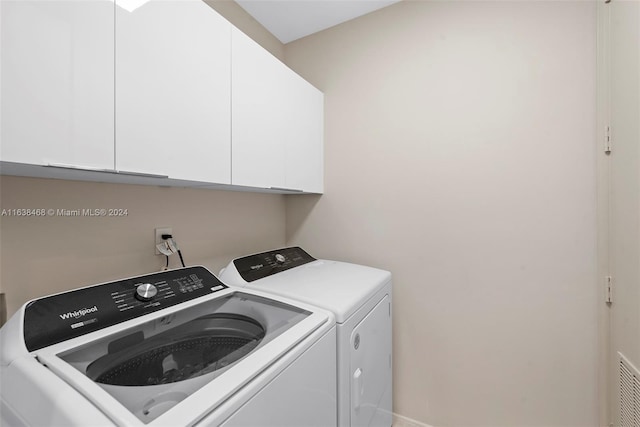 laundry room featuring cabinets and independent washer and dryer