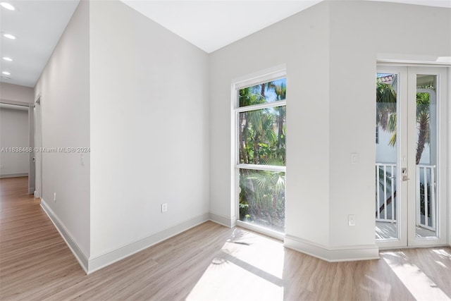 spare room with french doors and light wood-type flooring