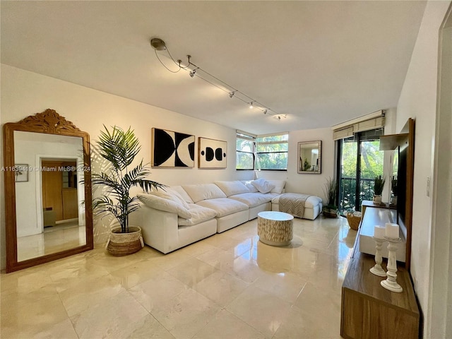 living room featuring rail lighting and light tile patterned floors