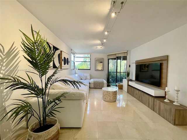 living room featuring light tile patterned flooring and track lighting