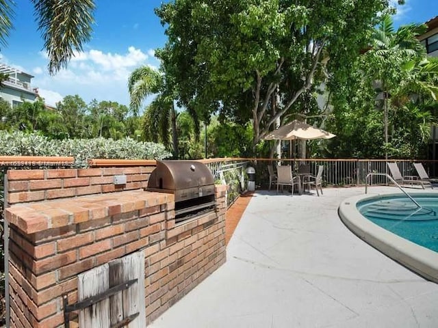 exterior space with exterior kitchen, grilling area, and a patio area