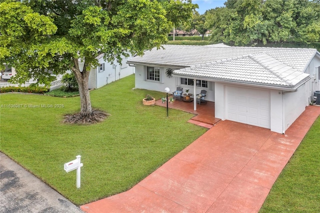 view of front of home featuring a garage and a front yard