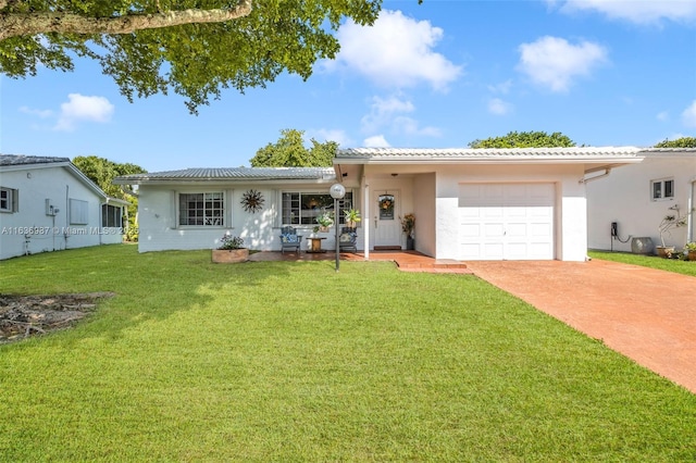 view of front of property with a front lawn and a garage