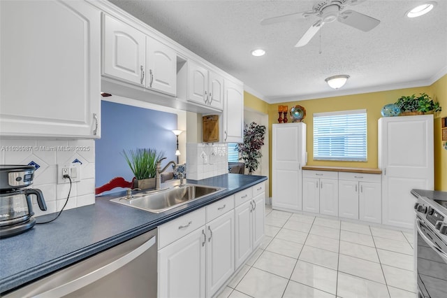 kitchen with decorative backsplash, sink, white cabinets, and stainless steel dishwasher