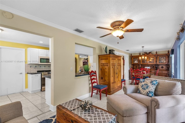 living room featuring ceiling fan with notable chandelier, light tile patterned floors, a textured ceiling, and ornamental molding