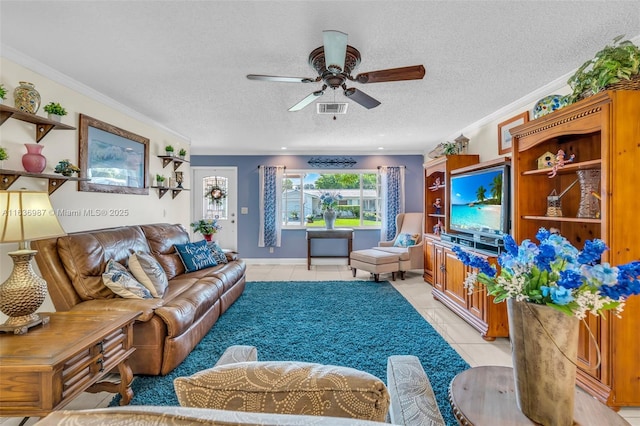 living room featuring crown molding, light tile patterned floors, a textured ceiling, and ceiling fan