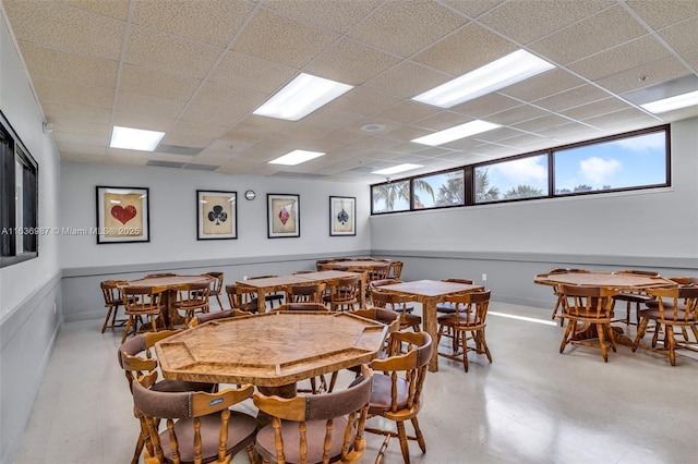 dining room featuring a drop ceiling