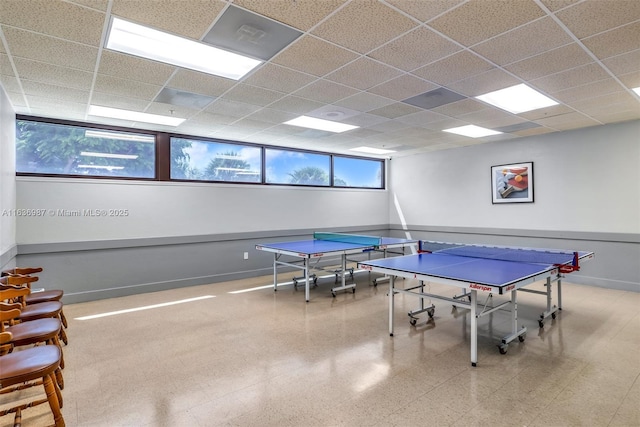 recreation room featuring a paneled ceiling