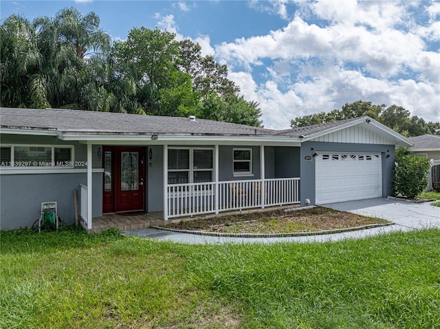 ranch-style home with a front yard, covered porch, and a garage