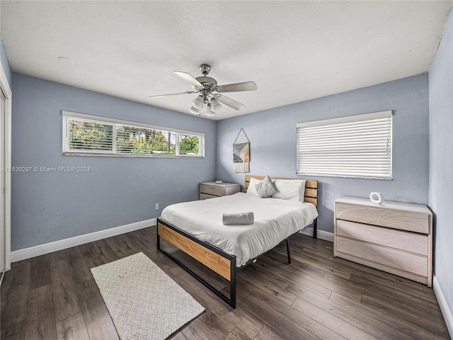 bedroom with ceiling fan and dark hardwood / wood-style flooring