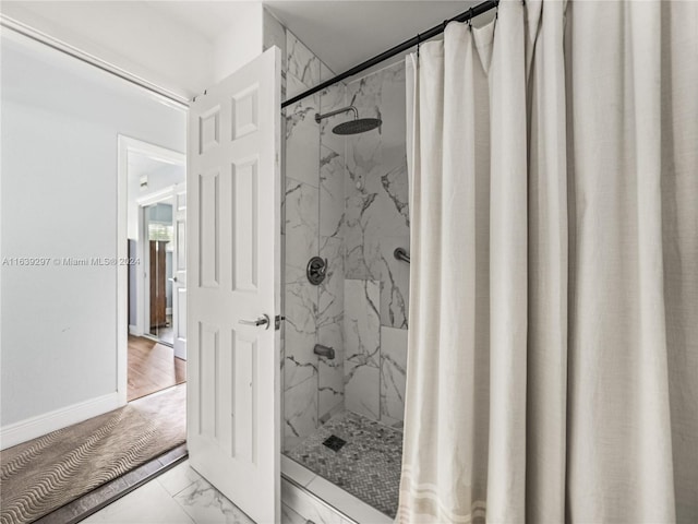 bathroom featuring wood-type flooring and a shower with curtain