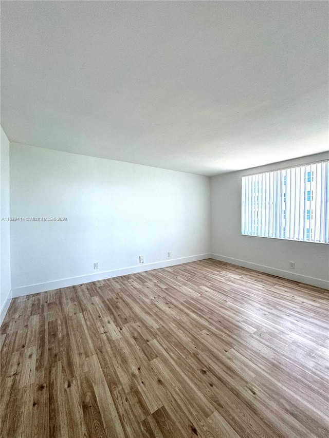 9195 Collins Ave Unit 801, Surfside, FL 33154 - empty room featuring baseboards and wood finished floors
