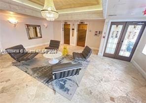 9195 Collins Ave Unit 801, Surfside, FL 33154 - living area with baseboards, french doors, and a tray ceiling