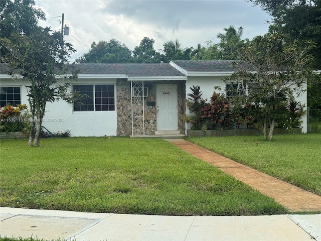 ranch-style house with a front yard