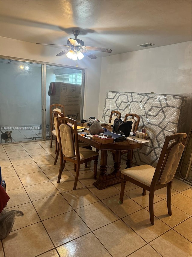 dining room featuring visible vents, a ceiling fan, and light tile patterned flooring