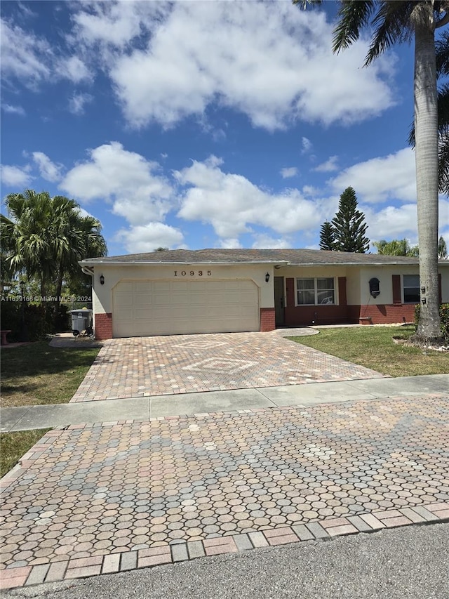 single story home with a front lawn and a garage