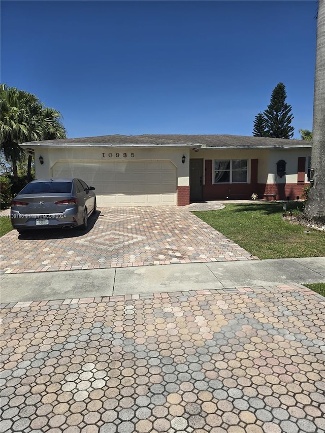 ranch-style house with a front lawn and a garage