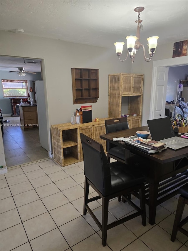 dining room featuring ceiling fan with notable chandelier and light tile patterned floors