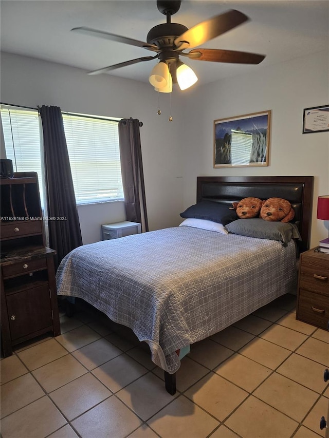 tiled bedroom featuring ceiling fan